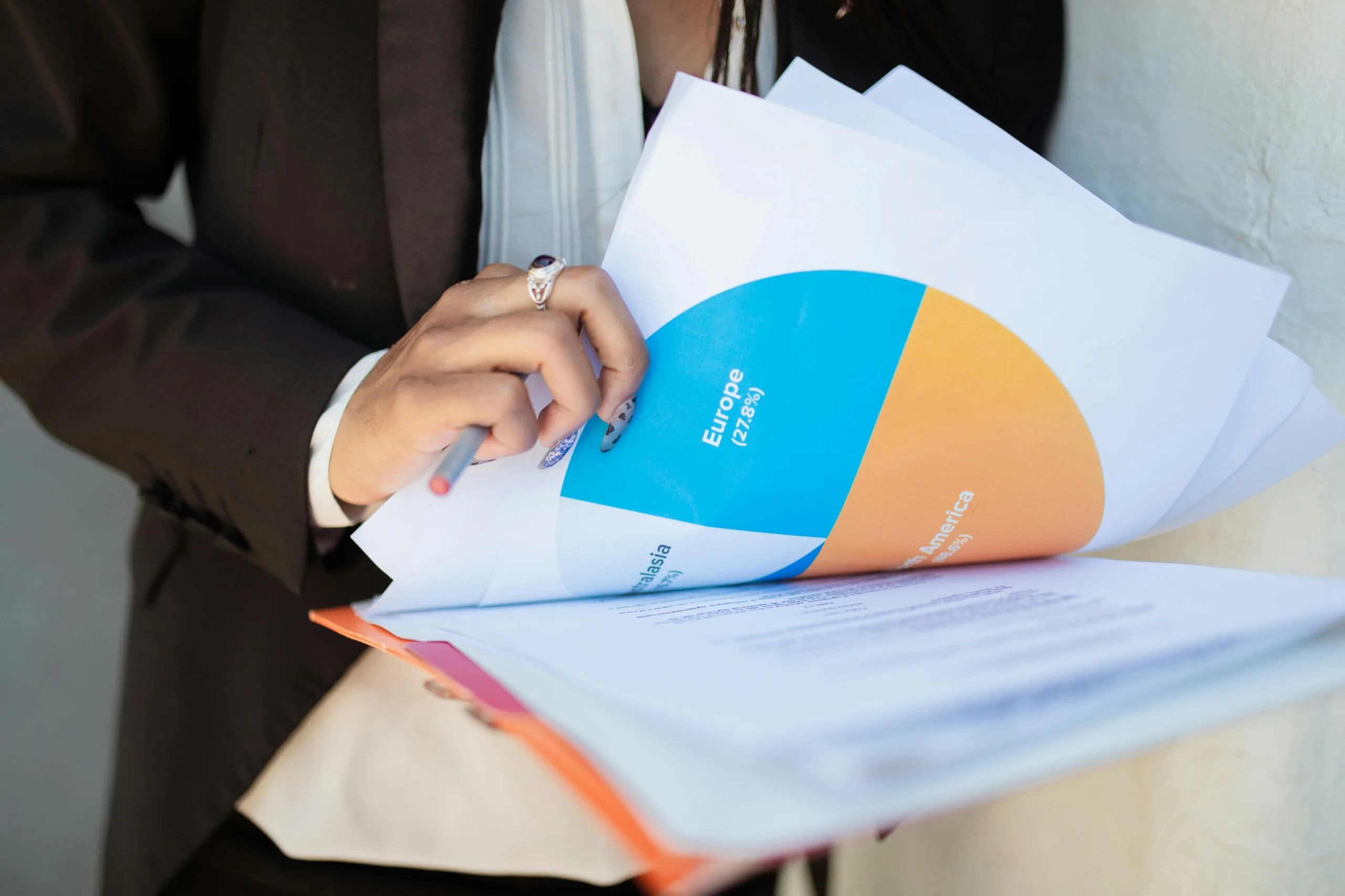 backdoor Roth IRA 2026: Close-up of a businesswoman reviewing financial documents with a colorful pie chart