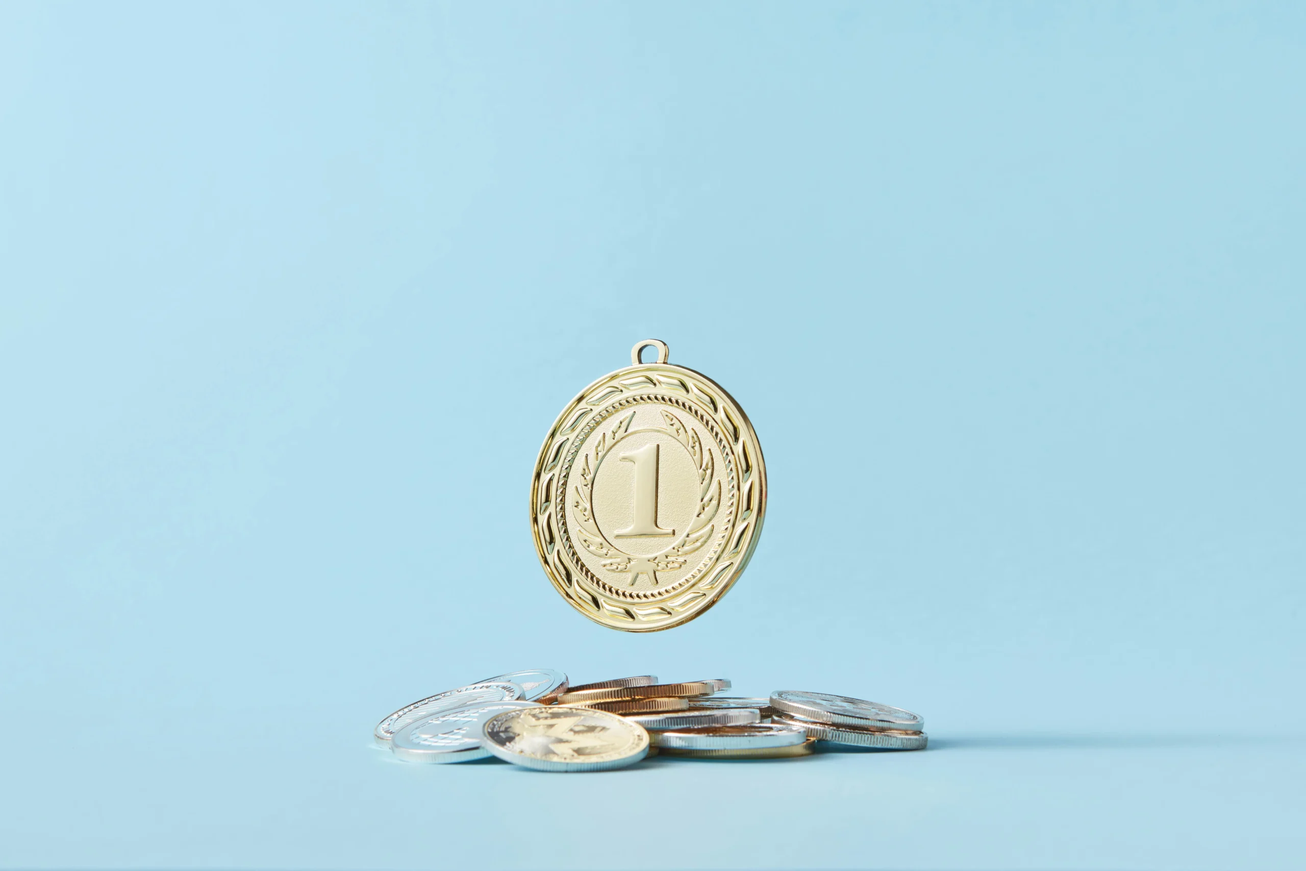 Barclays Aviator cards — A gold medal and pile of coins on a light blue background representing achievement and savings.