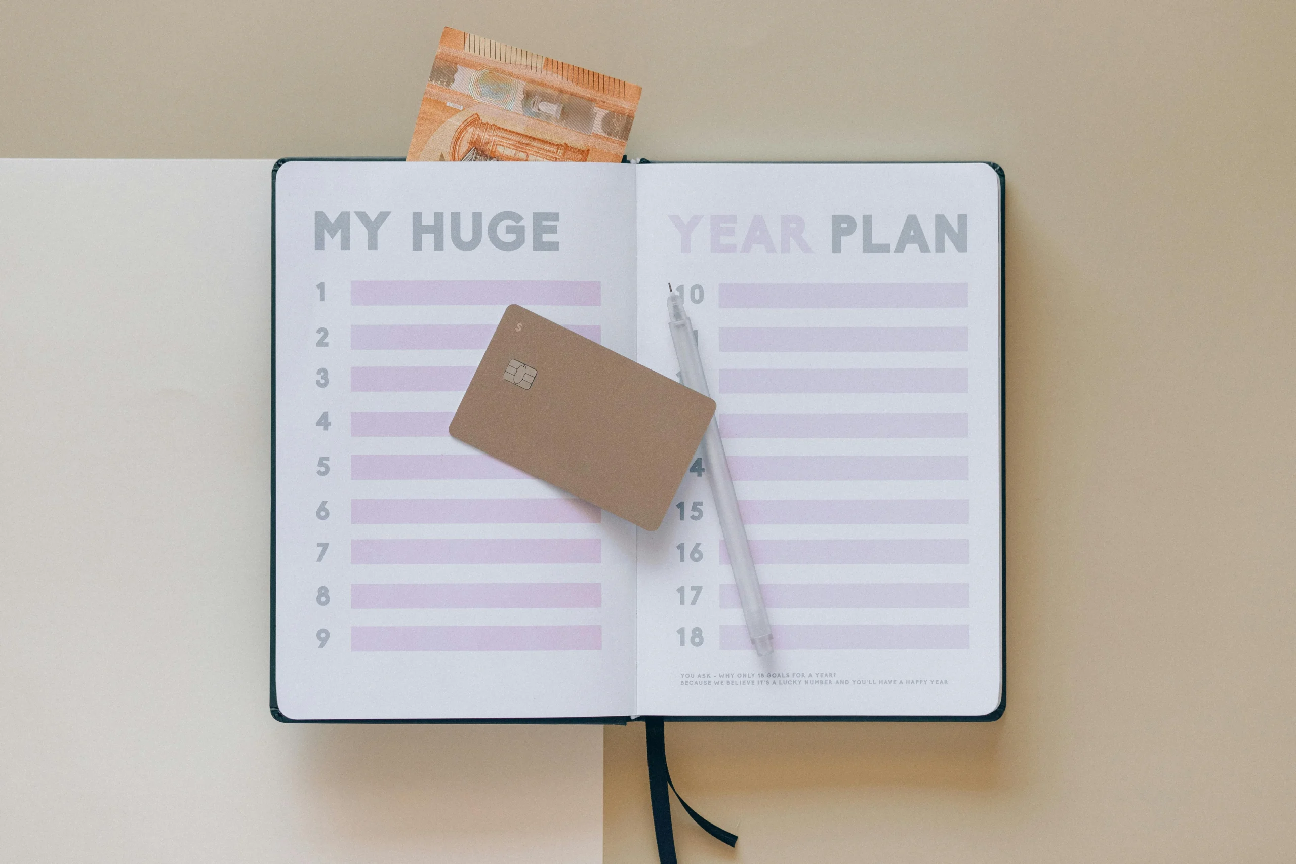 credit card utilization strategy 2026: Open planner with a credit card and pen, perfect for financial planning visuals