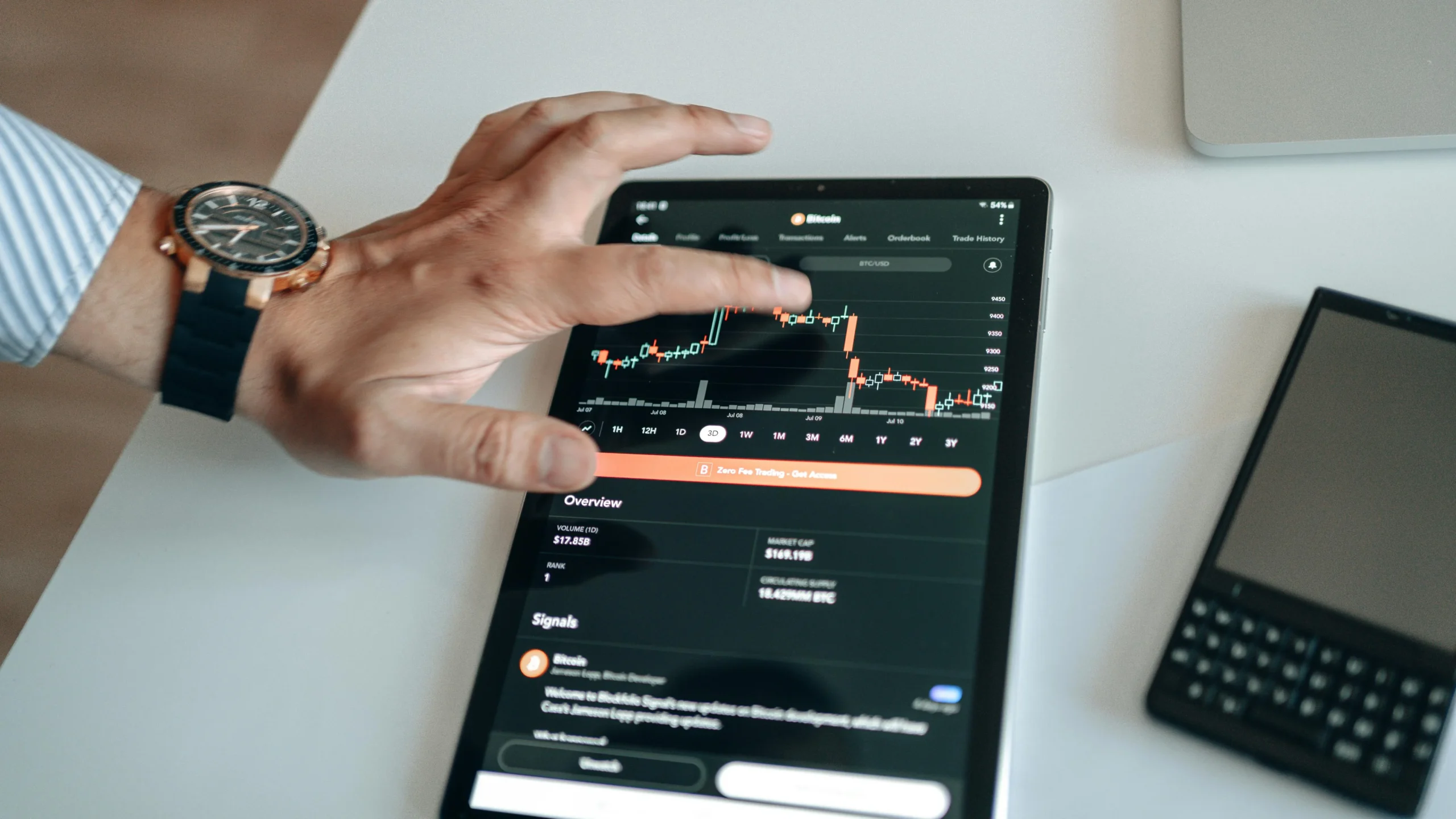 Gen Z financial literacy — A person analyzing cryptocurrency market trends on a tablet device displaying digital charts.