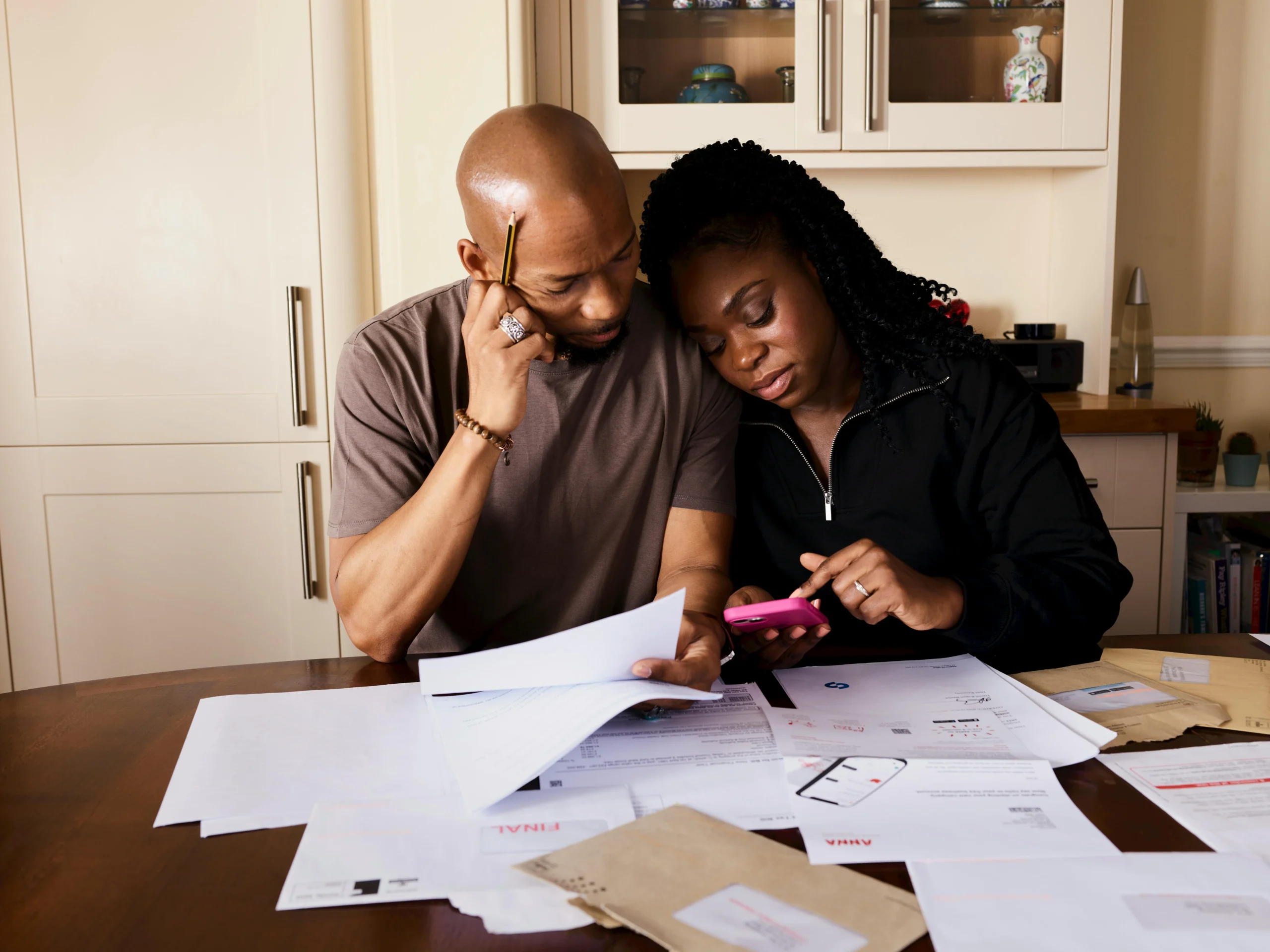 FAFSA asset protection strategies 2026: 7 Proven Moves 1 FAFSA asset protection strategies 2026: A couple sits at a table managing domestic finances, evaluating documents and using a