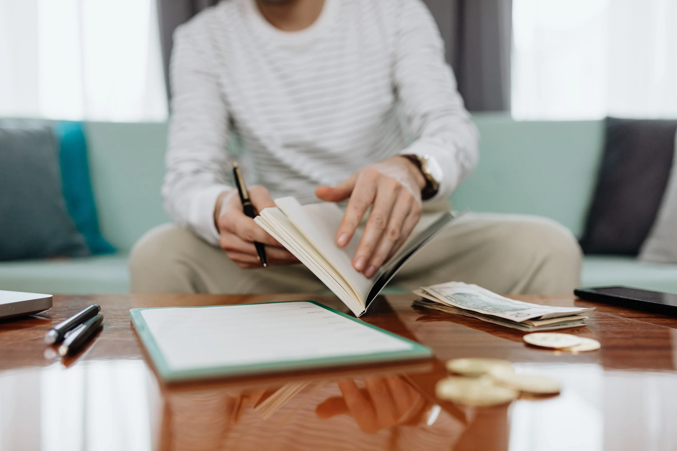 HELOC vs cash out refinance 2026: 7 Ultimate Cost Tips 1 HELOC vs cash out refinance 2026: Individual reviewing finances at a table with notebook, money, and laptop