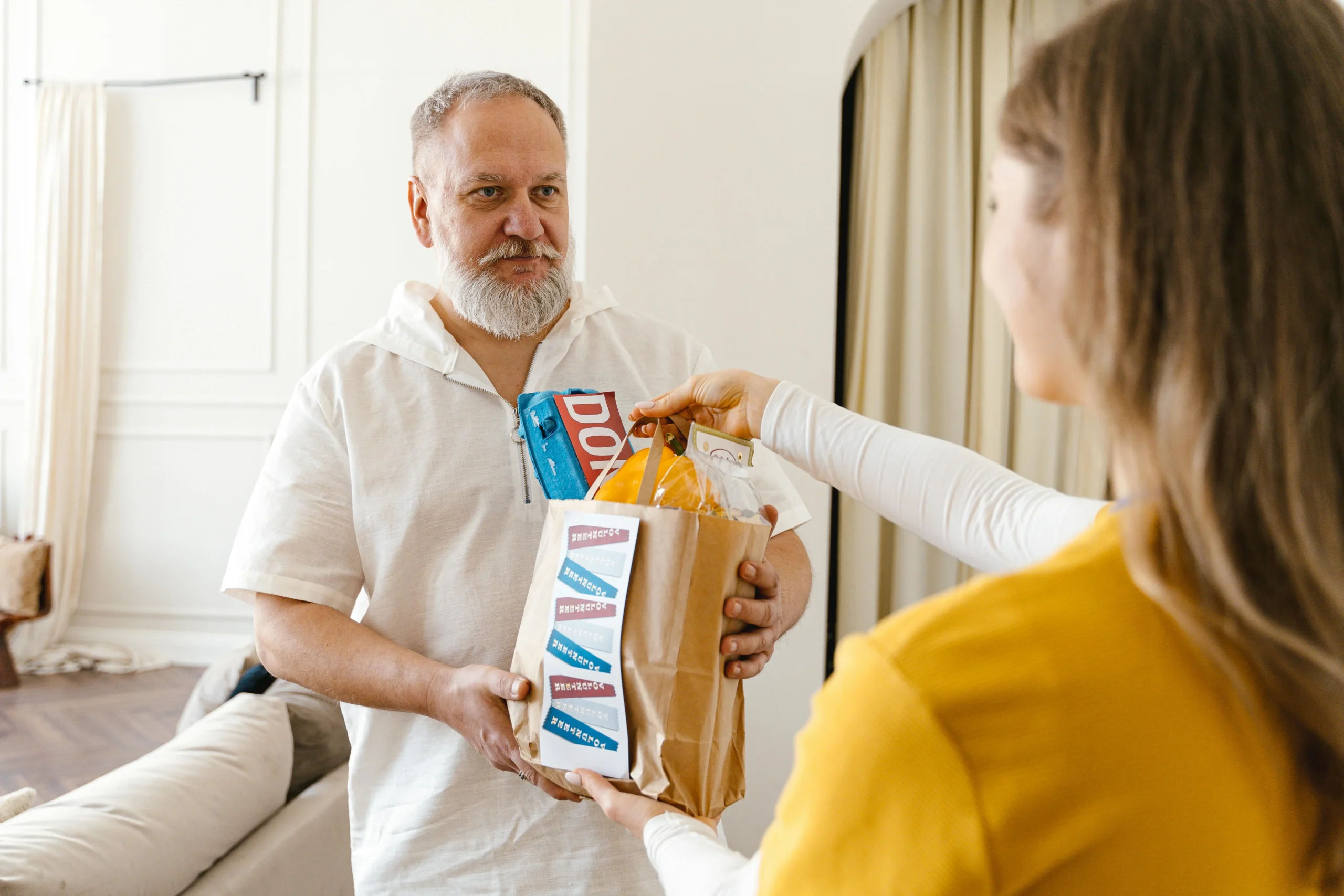 Qualified Charitable Distributions 2026: 7 Proven Ways 1 qualified charitable distributions 2026: An elderly man with a beard receiving a donation in a paper bag indoors, highlightin