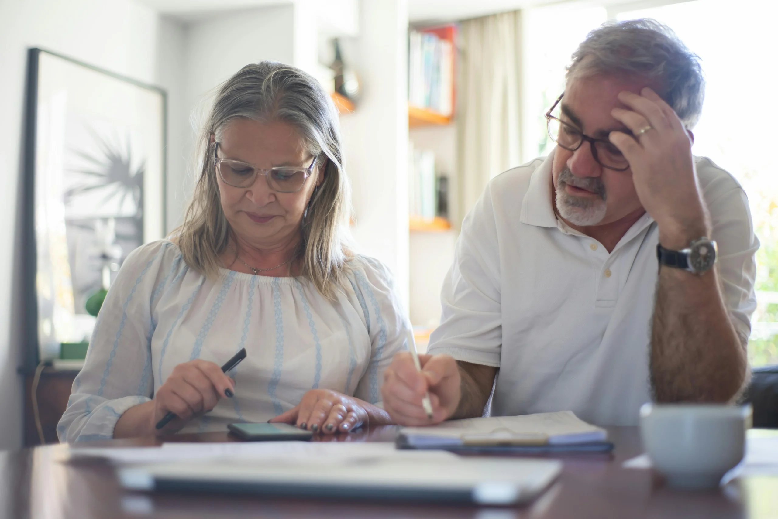 RMD Rules 2026: Ultimate Guide — Avoid Costly Penalties 1 RMD rules 2026: Senior couple calculating expenses at home office desk with documents and notes
