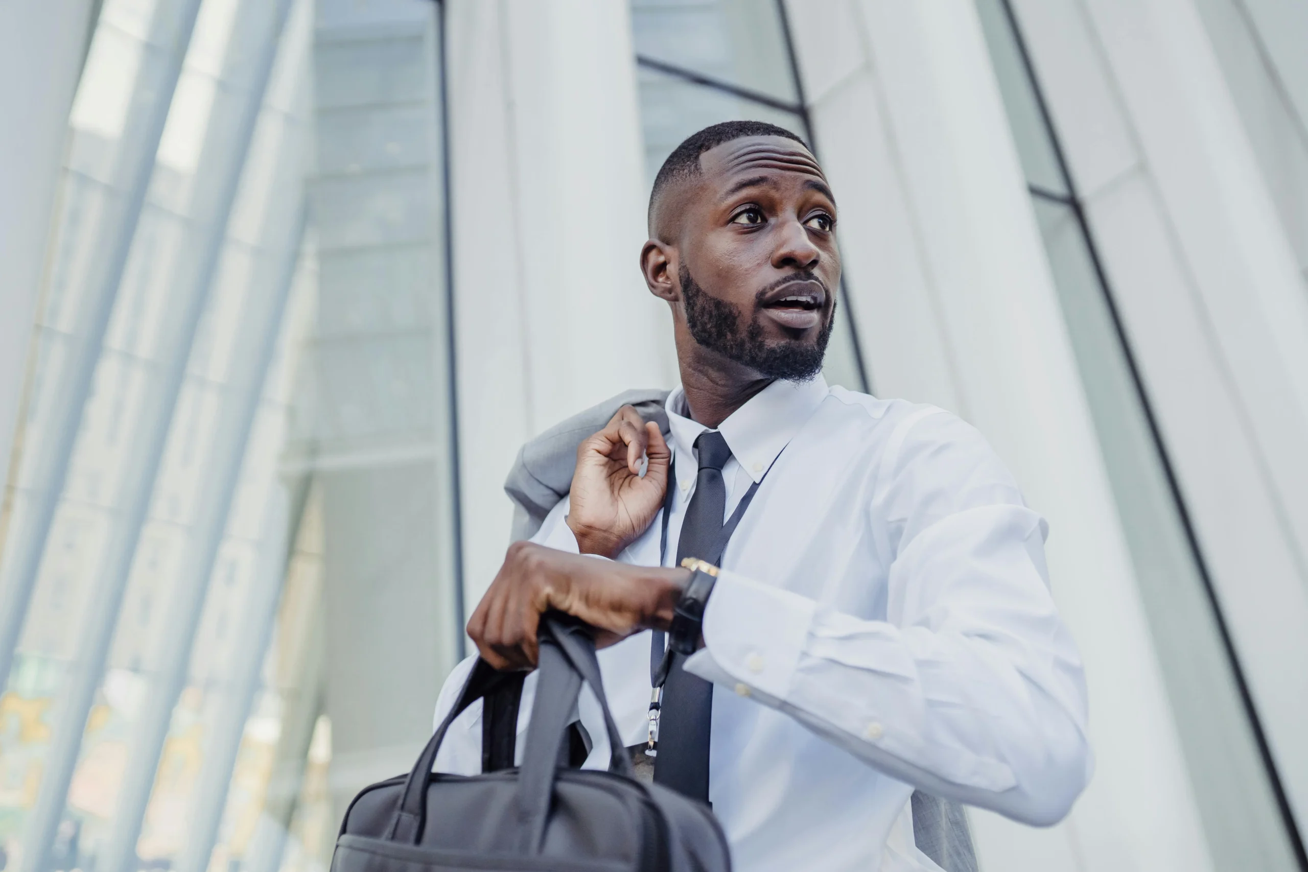 solo 401k vs SEP IRA 2026: A professional businessman with a bag adjusting his tie outdoors
