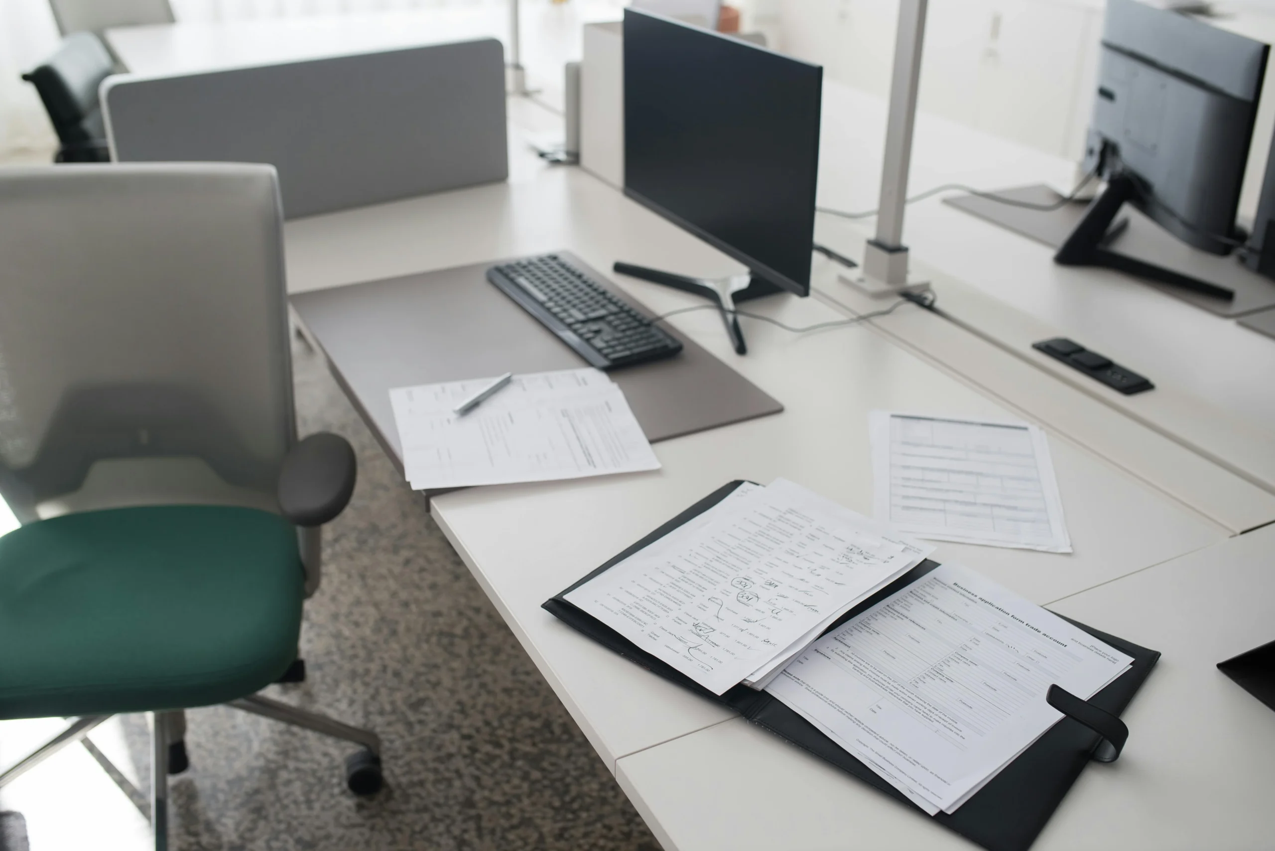 year end financial checklist 2026: A clean and organized office desk with documents, a computer, and chair in a modern worksp