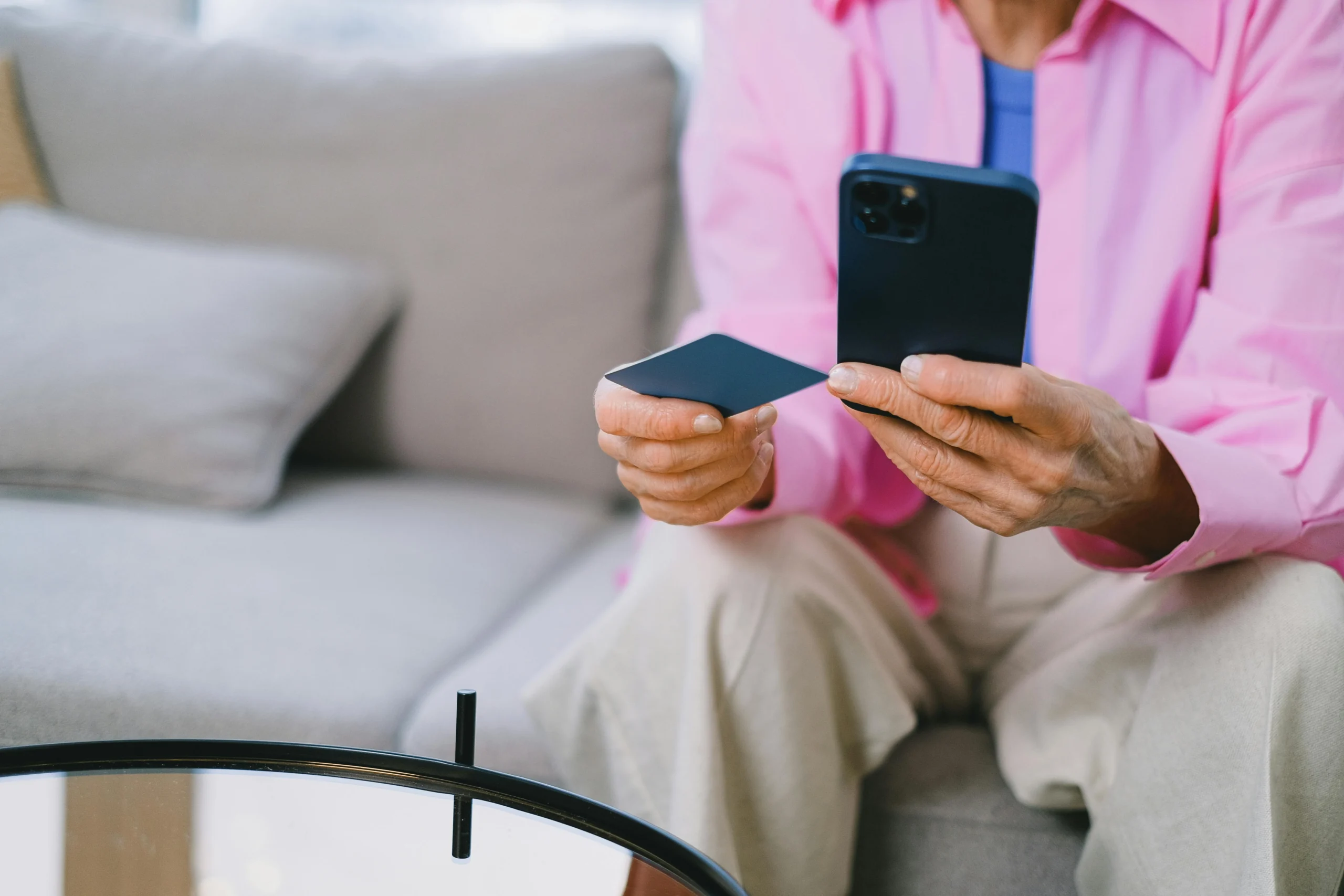 High Yield Savings vs Treasury Bills 2026: Ultimate Guide 2 high yield savings vs treasury bills 2026: Elderly person making an online payment with credit card using smartphone, seated