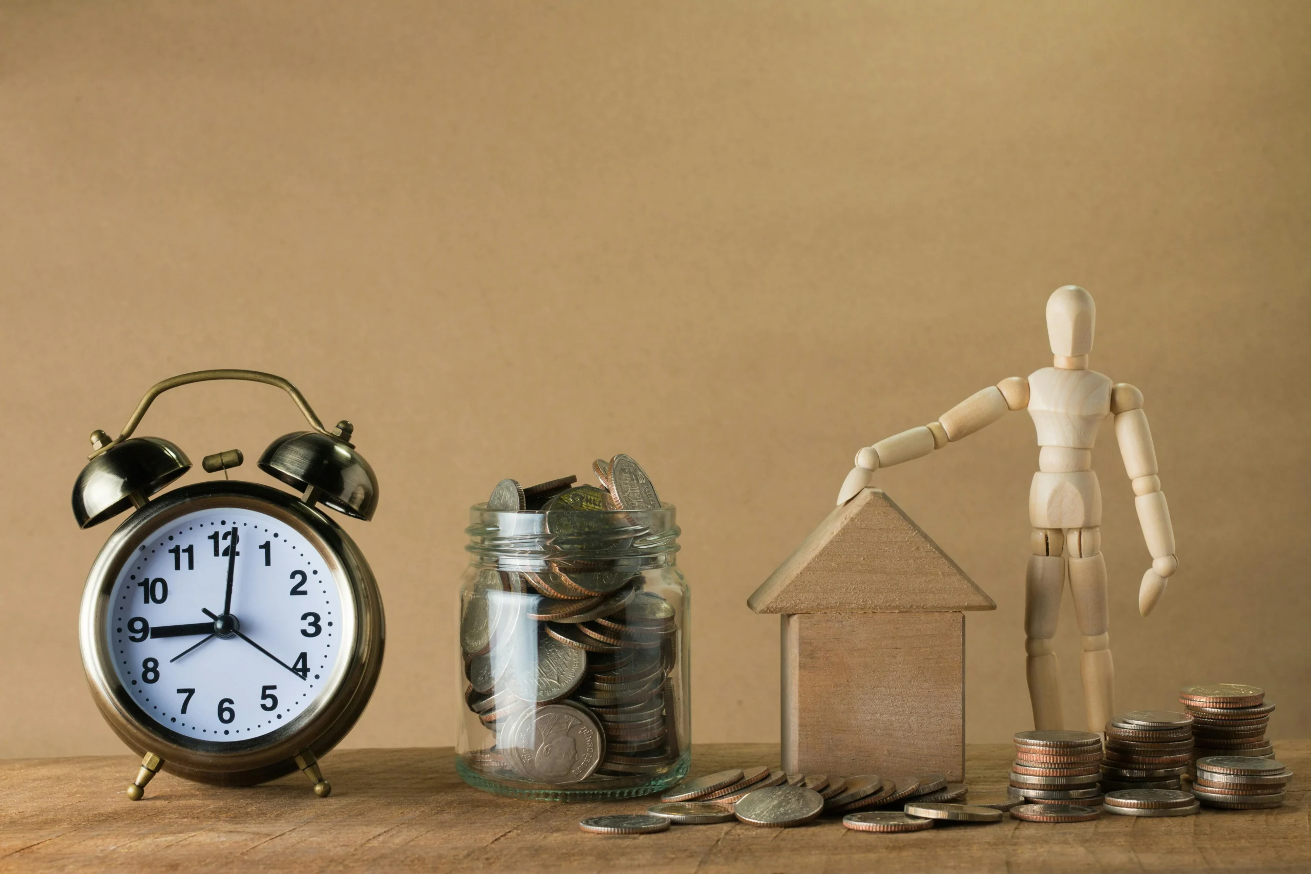 Homeowners Insurance Deductible Strategy 2026: 7 Proven Tips 3 homeowners insurance deductible strategy 2026: Wooden mannequin with a house, coins, and clock symbolizing time and financial