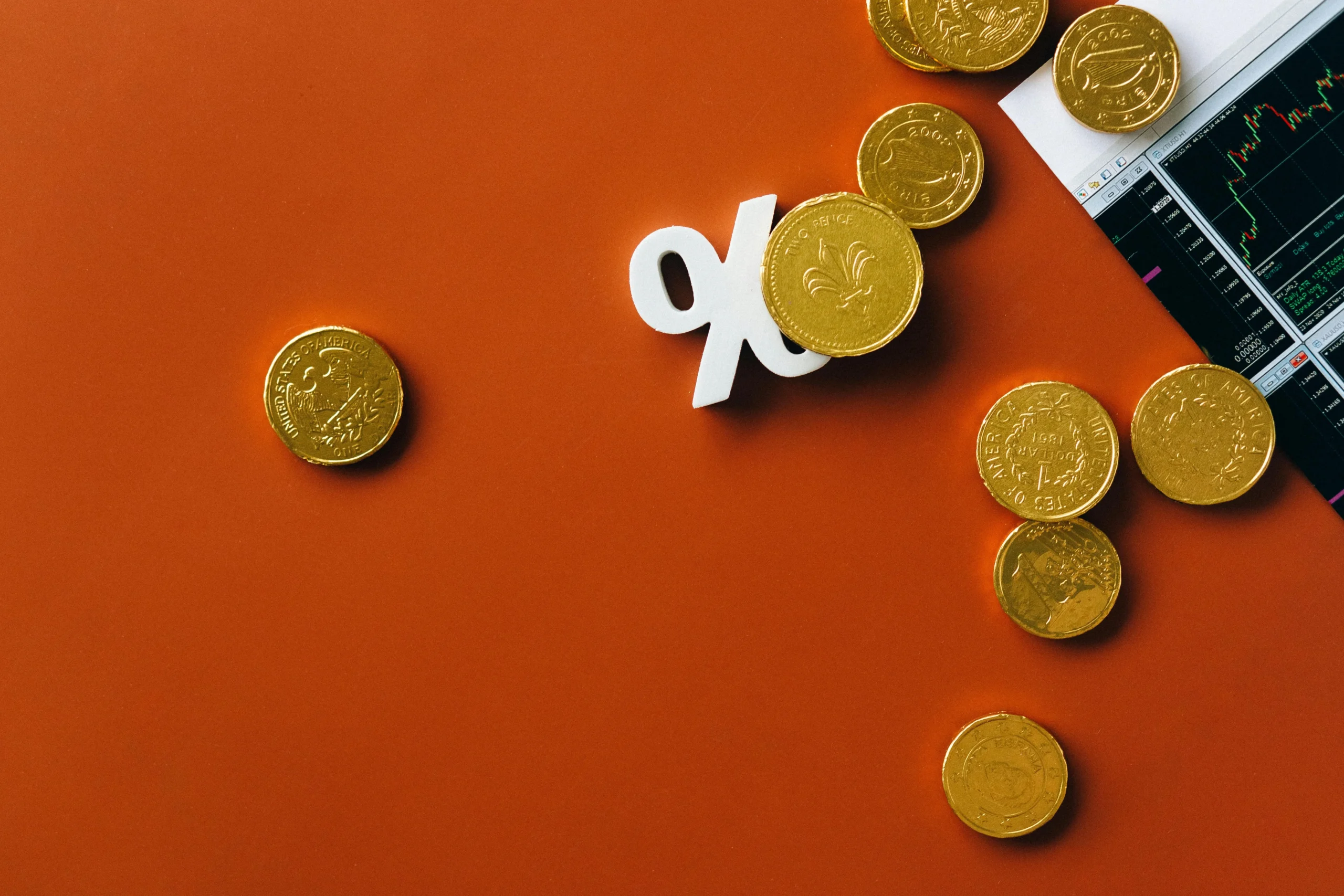 HSA Investment Strategy 2026: Ultimate Guide - Proven Plan 3 HSA investment strategy 2026: Gold coins scattered with a stock market graph and a percentage symbol on an orange background