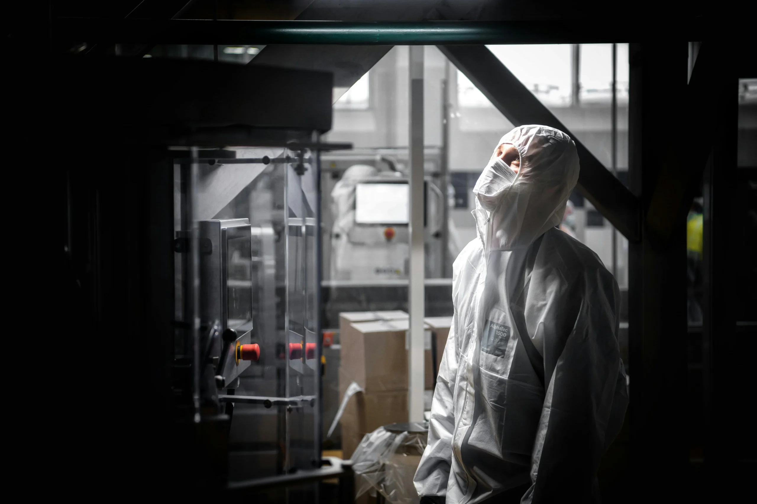 identity diversification — A man in protective gear works indoors at a factory in Moscow, Russia.