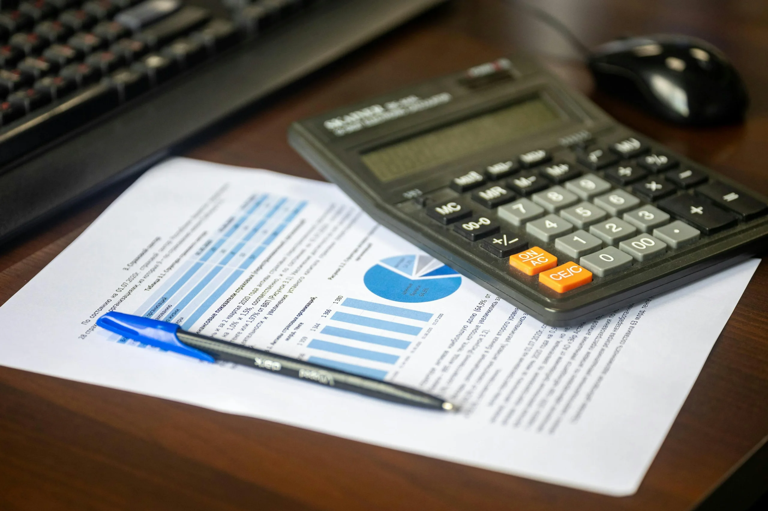 Qualified Charitable Distributions 2026: 7 Proven Ways 2 qualified charitable distributions 2026: Desk with calculator, financial report, and pen, suggesting business analysis