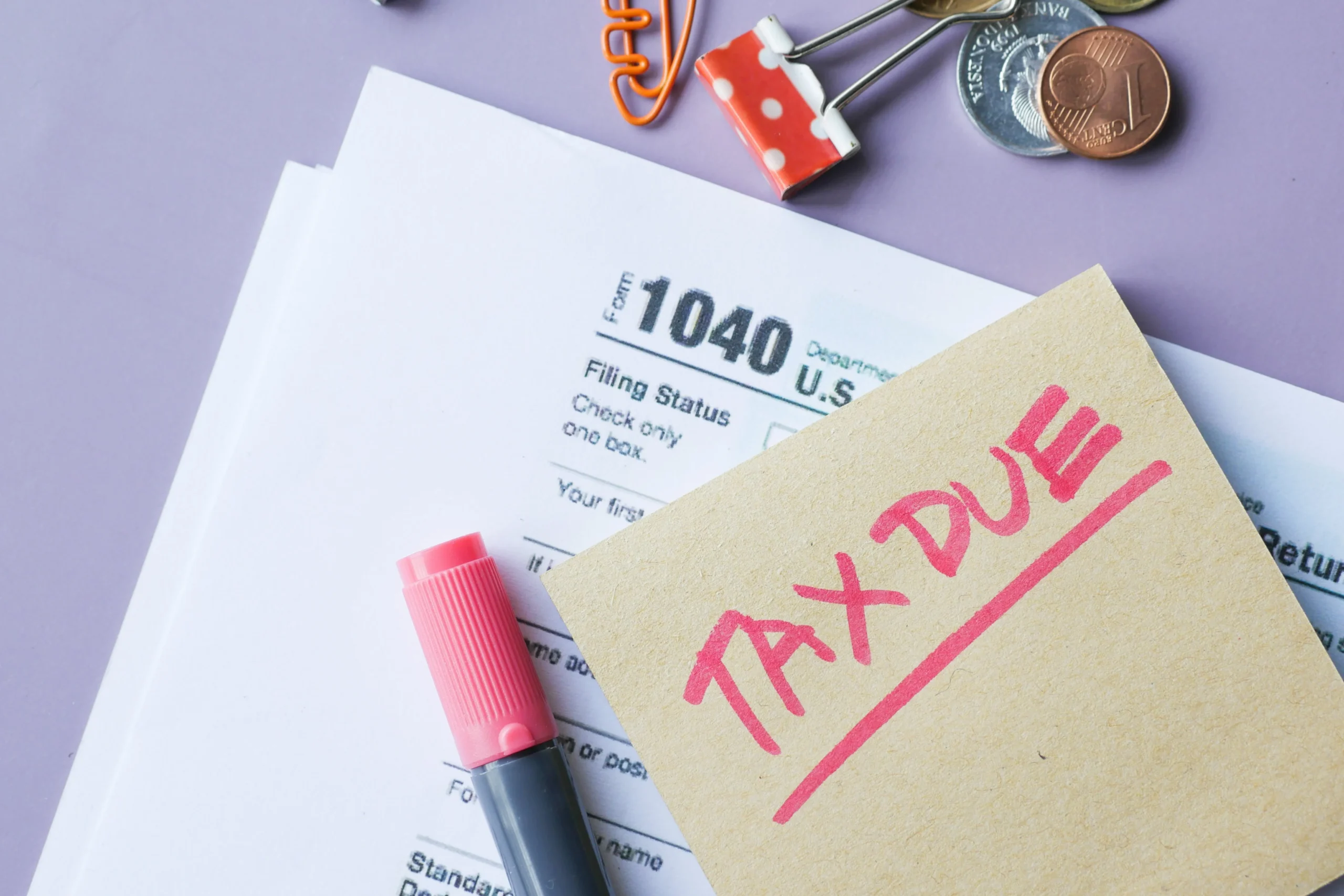 RMD Rules 2026: Ultimate Guide — Avoid Costly Penalties 3 RMD rules 2026: Close-up of IRS Form 1040 with 'Tax Due' note and stationery on a desk