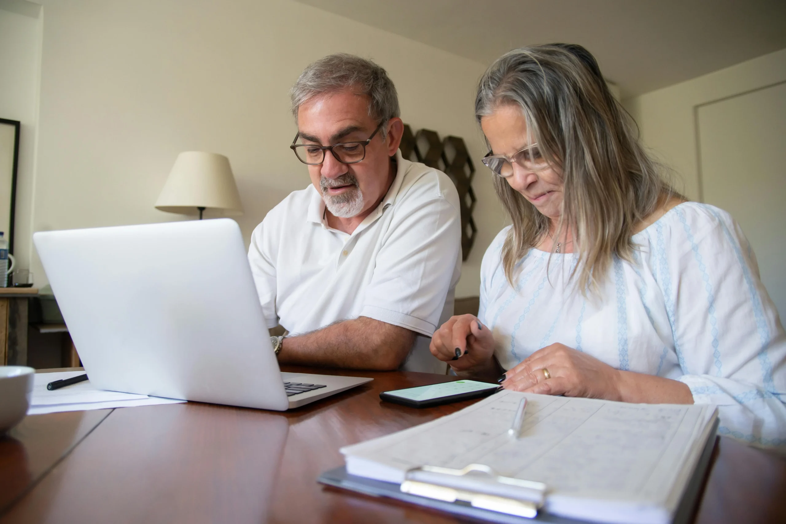 SEP IRA vs solo 401k side hustle 2026: Ultimate Guide 2 SEP IRA vs solo 401k side hustle 2026: Senior couple working together on documents with laptop and phone at home