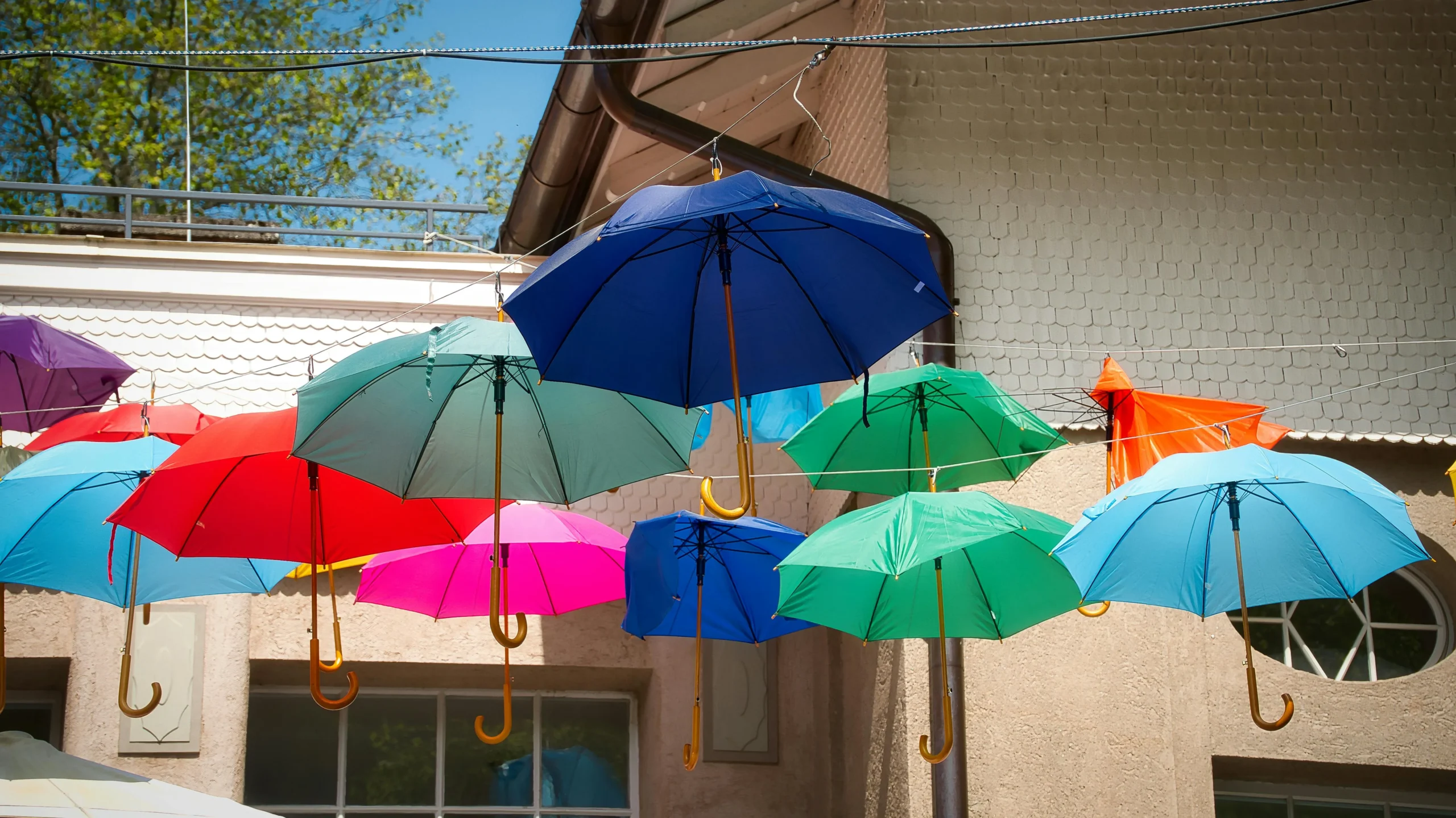 Umbrella Insurance 2026: Ultimate Guide to Protect $Millions 2 umbrella insurance 2026: Vibrant umbrellas hanging outdoors in Bad Wildbad, showcasing a playful and colorful arrangement